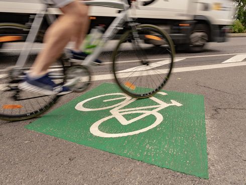 Radfahrer fährt auf Radweg mit Fahrradpiktogramm